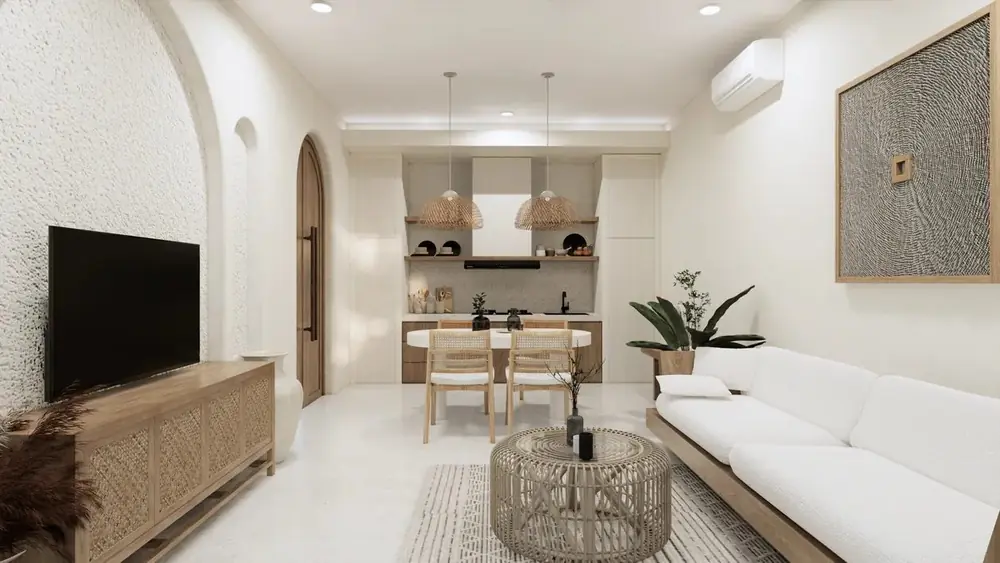 Villa living room in pale timber and rattan, with a woven coffee table and white sofa